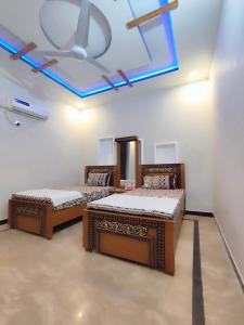 伊斯兰堡Lavish Inn Islamabad的天花板客房内的两张床