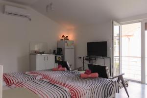 盖夫盖利亚Magnolia Apartments的卧室配有一张大床和粉红色枕头。