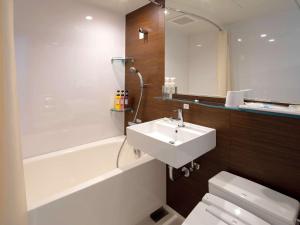 伊势市伊势舒适酒店的浴室配有盥洗盆、卫生间和浴缸。