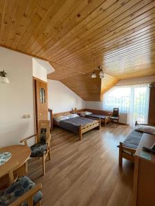奥斯特罗沃ASIA- Pokoje Gościnne i Studia的大房间设有两张床和木制天花板