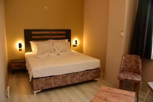 库萨达斯Villa Sevilla的一间卧室,卧室内配有一张床和一把椅子