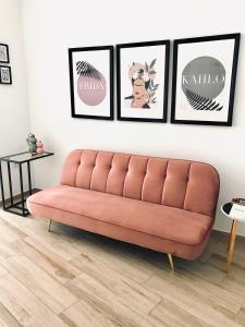 梅里达Apartamentos Élite - Art Collection - Frida的客厅的沙发,墙上挂着四张照片