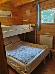 德沃吕伊Chalet Mataya à la Joue du Loup的小屋内设有一间带两张双层床的卧室