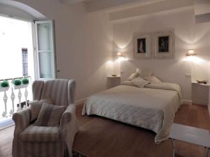 阿尔本加La dimora del Conte Bracco B.的一间卧室配有一张床和一把椅子