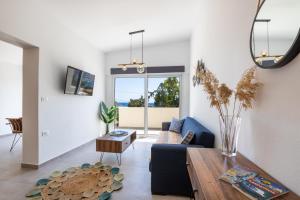 卡尔帕索斯Aronia Luxury Apartments Karpathos的客厅配有沙发和桌子