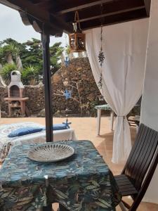 蒂亚斯Islabella Lanzarote habitaciones en Villa con entrada particular的庭院配有桌椅。