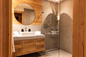 弗拉绍冬季农民酒店的浴室配有盥洗盆和带镜子的淋浴