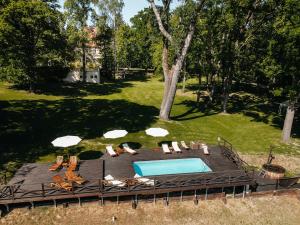 Sieraków谢拉库夫庭院酒店的享有带椅子和遮阳伞的游泳池的上方景色