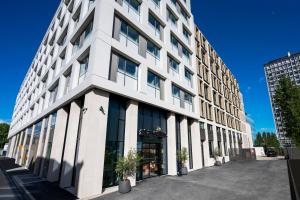库尔布瓦Staycity Aparthotels Paris La Defense的街道上带窗户的大型白色建筑