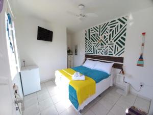布希奥斯Casa Colomba的一间卧室配有一张黄色和蓝色毯子的床