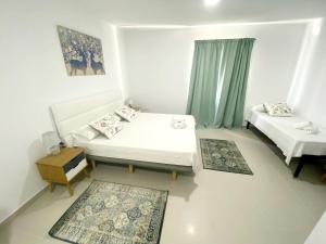 奥里韦拉斯科斯塔Villamartin Hotel GHB的小房间设有两张床和一张桌子