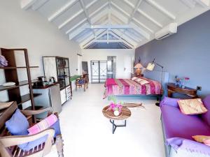 格兰德凯斯Blue Room in a shared Villa Diamant with communal pool and sea view的一间卧室配有一张床、一张沙发和一张桌子
