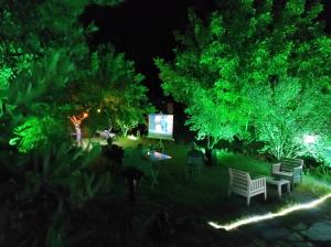 埃杰阿巴德Bahçeli Konak的公园里晚上有一组椅子和屏幕