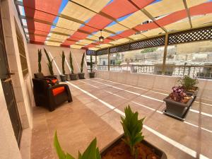 安曼Villa Mira GuestHouse 2 - Downtown Central Amman - AL DIYRIH的空的大堂,拥有色彩缤纷的天花板和植物