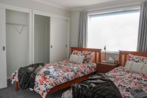 纳皮尔City Centre Escape的一间卧室设有两张床和窗户。