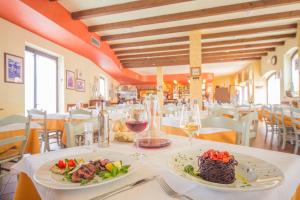 多索博诺安堤齐科帝里酒店的餐桌上放有两盘食物的餐厅