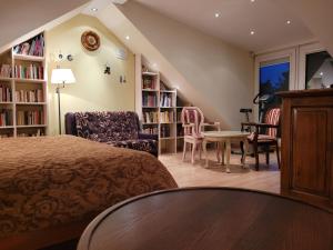 奈达罗马风格公寓酒店的卧室配有一张床和一张桌子及椅子