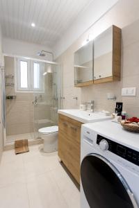 科孚镇oliva e mare luxury suite的一间带水槽和洗衣机的浴室