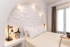 圣安娜纳克索斯Sand & Sea Private Pool Villa Agia Anna的白色卧室,设有白色的大墙