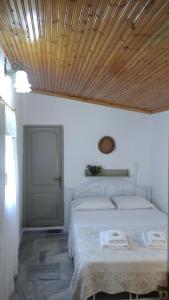 萨尔蒂Dino's Cottage的一间卧室设有一张木天花板床。
