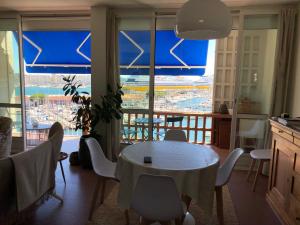 土伦RIOPASSIONS, GRAND T3, BELLE VUE MER的一间带桌椅的用餐室和一个阳台