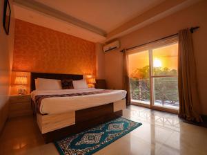 达兰萨拉Hotel 360 by D'Polo Dharamshala的一间卧室设有一张床和一个大窗户