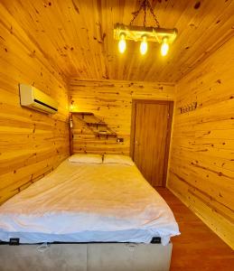 特拉布宗Trabzon Mountain House-UZUNLU的小木屋内一间卧室,配有一张床
