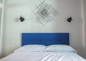 多列毛利诺斯La chica de la perla的一张蓝色床头板和上面两个灯的床