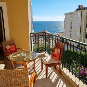 斯韦蒂·斯特凡拉雷斯公寓酒店的一个带桌椅的海景阳台