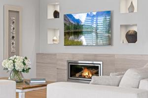 Lake IllawarraLittle Lake Beach House - Beachside 4 Bedroom Luxury Home的客厅设有壁炉和电视。