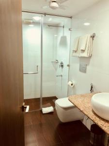 新德里尼姆旅馆的带淋浴、卫生间和盥洗盆的浴室