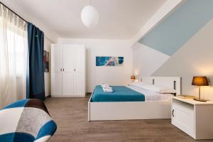 墨西拿Blue Apartment Messina的白色卧室配有床和书桌