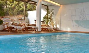蒂罗尔-泽费尔德克里斯蒂娜酒店的游泳池旁设有桌椅的游泳池