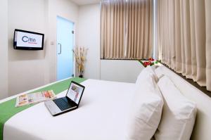 吉隆坡康帕斯酒店集团思庭老清真寺酒店的酒店客房,床上配有笔记本电脑
