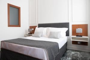 罗马Domus Prestige -Suite Repubblica- In Central Rome的白色卧室配有一张带白色枕头的大床