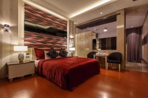 高雄麗登汽車旅館的一间卧室配有一张红色大床和一张书桌