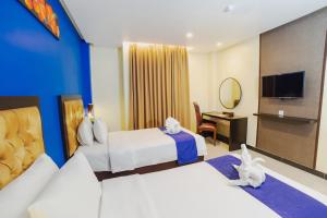 Parkside Star Hotel Jayapura客房内的一张或多张床位