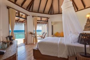 丹格迪Drift Thelu Veliga Retreat的一间卧室设有一张床,享有海景