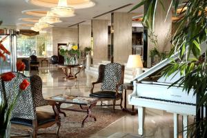 开罗开罗塔及赌场圣淘沙酒店的大堂的白色钢琴,配有椅子和桌子