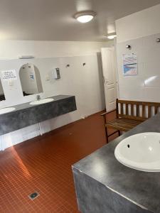 多维尔Une vedette à Deauville的一间带水槽、柜台和长凳的浴室