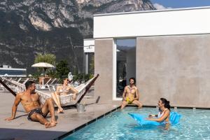 加尔达湖滨Aris Apartments & Sky Pool - TonelliHotels的一群人坐在游泳池里