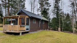 诺尔泰利耶Fritidshus Rostockvägen 40B - Guest House - Bring own bed sheets的田野中间的小木屋