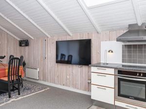 罗莫柯克比6 person holiday home in R m的厨房配有壁挂式平面电视。