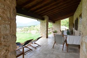 诺尔恰Casale dei Briganti的石头建筑中带桌椅的庭院