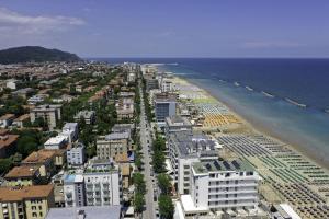 佩萨罗Amadei Hotel Figaro & Apartments的享有海滩和建筑的空中景致