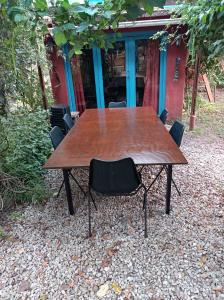 米拉玛Casa de campo, surf, pesca y golf的一张木桌,四周摆放着黑椅子