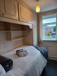 博尔顿Immaculate 3-Bed House with free parking in Bolton的一间卧室,床上有背包