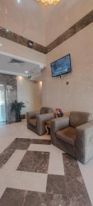 麦地那فندق ربوة الصفوة 8 - Rabwah Al Safwa Hotel 8的客厅设有两张沙发和一台墙上的电视