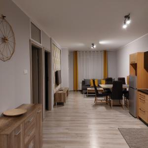 科沃布热格Komfortowy apartament w zachodniej części Kołobrzegu的一间带桌子的客厅和一间餐厅