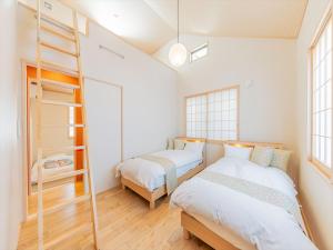 东京宿家千の里的一间卧室设有两张床和梯子